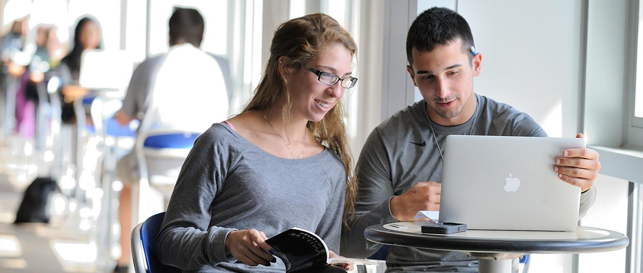 Student smiling in class at the University of Akron